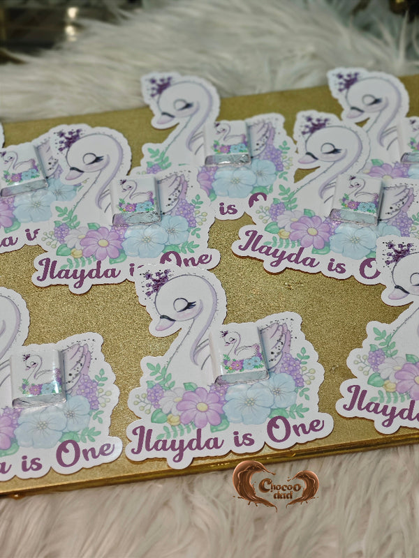 Sticker sheet with swan design and text 'Ilayda is One' on a gold card.