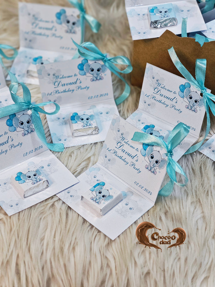 Set of birthday party invitations with blue ribbons on a textured surface