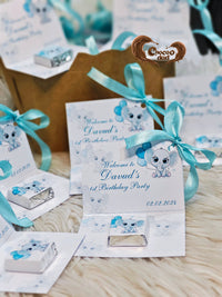 Children's birthday party invitations with blue ribbons and a Choco dad logo.