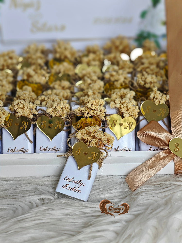 Decorative items with gold hearts and ribbons on a textured surface