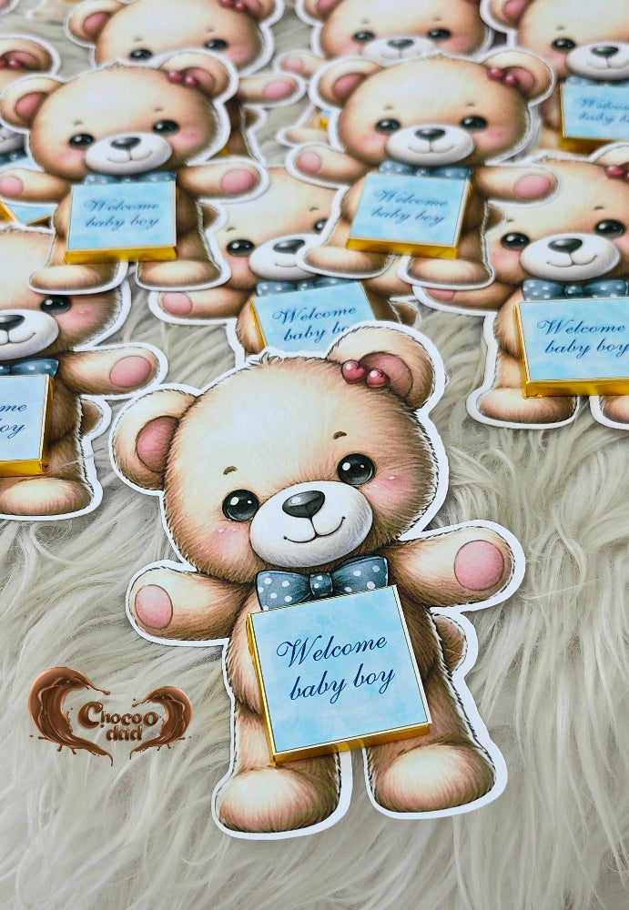 Stickers of teddy bears with baby shower messages on a textured surface