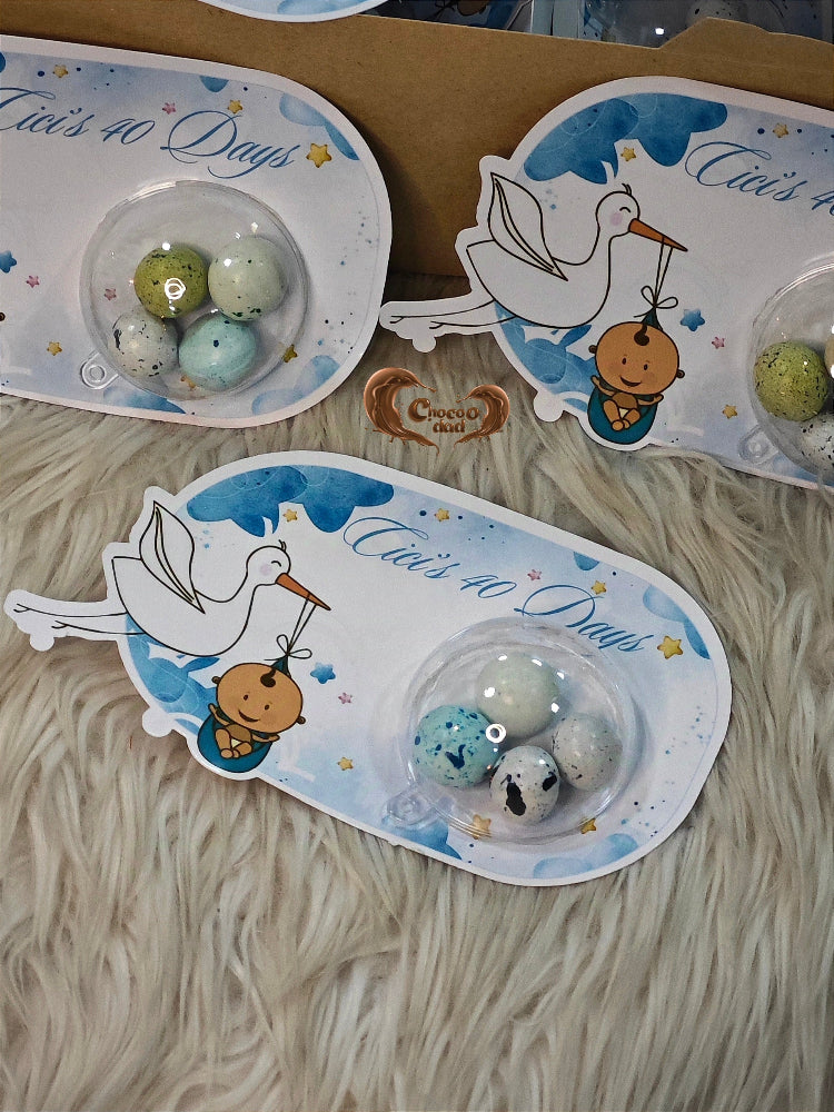 Decorative plates with stork and baby design, featuring text 'It's 40 Days'.